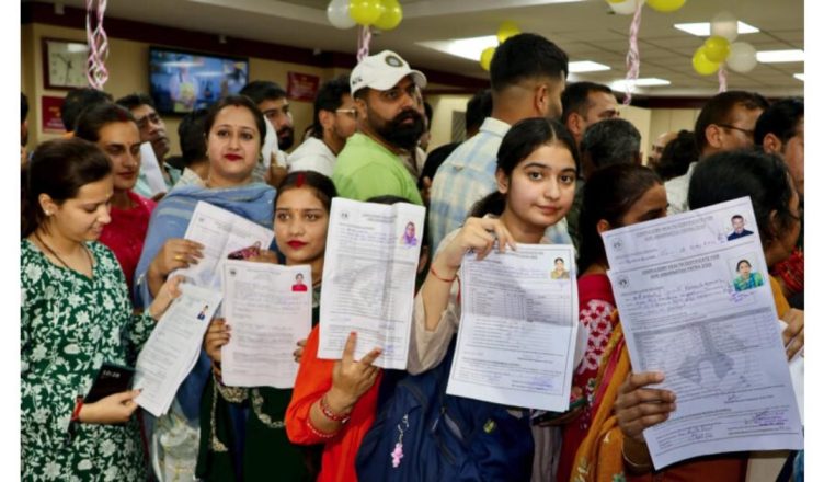 Devotees standing in long queues at bank counters in Jammu for Amarnath Yatra registration 2026