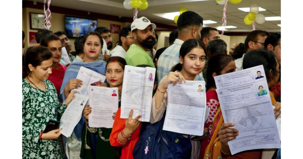 Devotees standing in long queues at bank counters in Jammu for Amarnath Yatra registration 2026