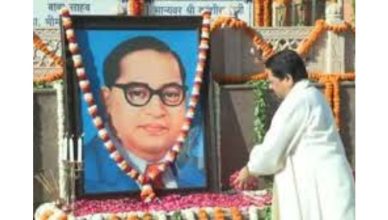 Mayawati paying floral tribute to Dr BR Ambedkar on Ambedkar Jayanti in Lucknow with supporters gathered nearby