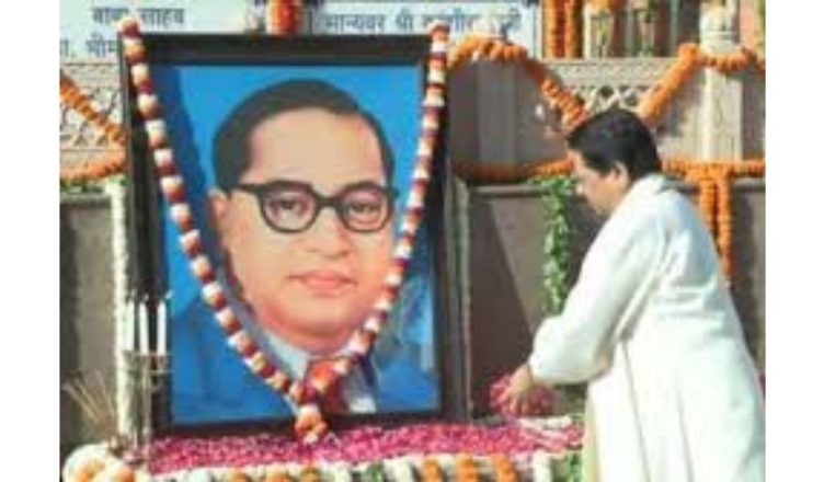 Mayawati paying floral tribute to Dr BR Ambedkar on Ambedkar Jayanti in Lucknow with supporters gathered nearby